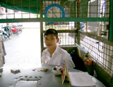 Boy selling boarding card of ferryboat
